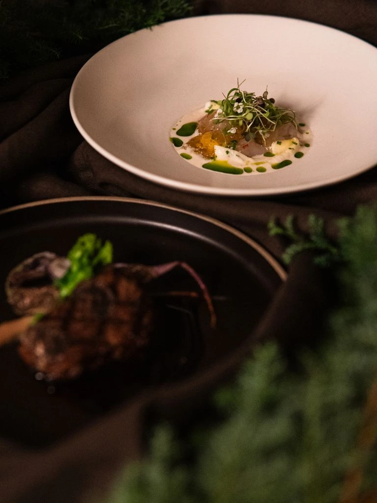 Seven courses of the Mar i Muntanya tasting menu, photographed on the candlelit terrace at dusk.