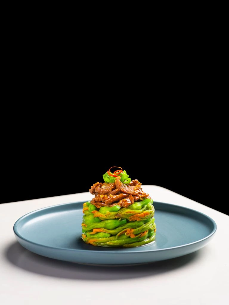 Signature Catalan dish photographed in the warm candlelight of Fanal Racou.
